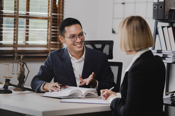 Lawyer meeting contact us concept: Lawyer businessman and woman working together with law book at...
