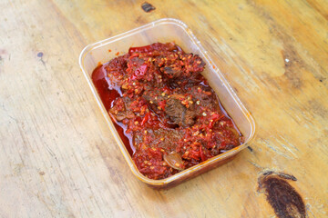 Dendeng Balado or Dendeng Batokok, and is a speciality from Padang, West Sumatra, Indonesia. Made from beef which is thinly cut then dried and fried before adding chillies and other ingredients
