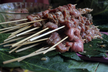 Goat satay in a cauldron that has been burned ready to be served
