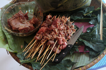 Goat satay in a cauldron that has been burned ready to be served
