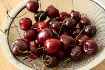 Cherries in a sieve on the table