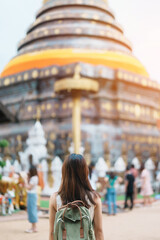 Young asian woman traveler in white dress with hat and bag traveling in Wat Phra That Lampang Luang, Tourist visit at Lampang, Thailand.. Asia Travel, Vacation and summer holiday concept