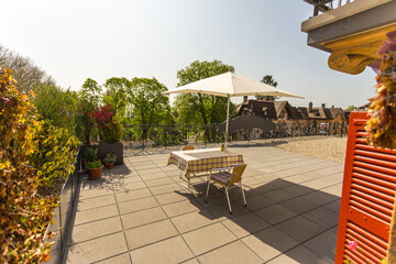 Table with umbrella on a sunny patio © Serjedi