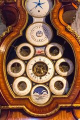 Old-fashioned wooden clock with clocks inside