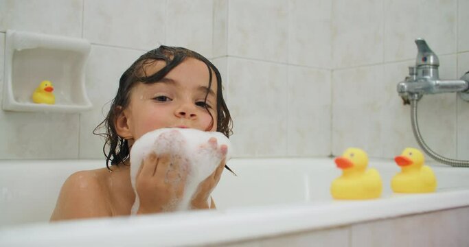 Childhood Bliss: A Happy Kid Bathing, Playing with Water, and Embracing Joyful Moments. High quality 4k footage