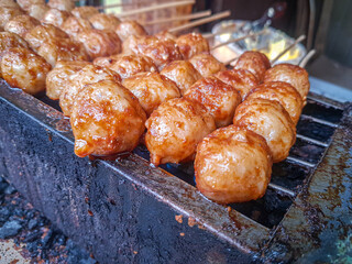 Indonesian food - Grilled meatballs ( Bakso Bakar) grilling outdoors on a barbeque grill.