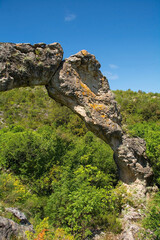 Kolac Rock Arch near Nerezisca on Brac Island, Croatia. A result of a mixture of steambank, wind, water and temperature erosion, and protected as a geomorphological monument of nature, it is made of l
