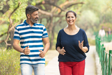 Indian couple doing jogging together at park.
