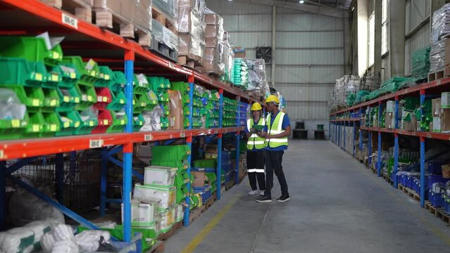 Warehouse Industrial and Logistics Companies. Dispatcher in uniform making inventory in storehouse.