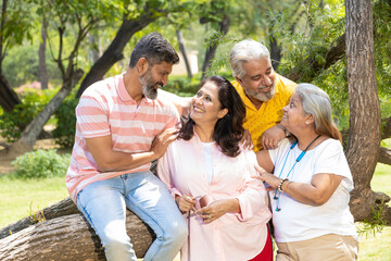 Fototapeta premium Indian family giving happy expression at park.