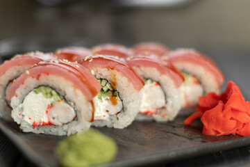 Sushi roll Maguro with tuna, shrimp, Philadelphia cheese on black background. Sushi menu concept. Japanese food.