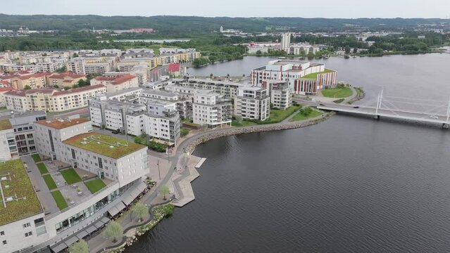 City on the lake aerial. Jonkoping lakefront, residential area and bridge. Sweden.