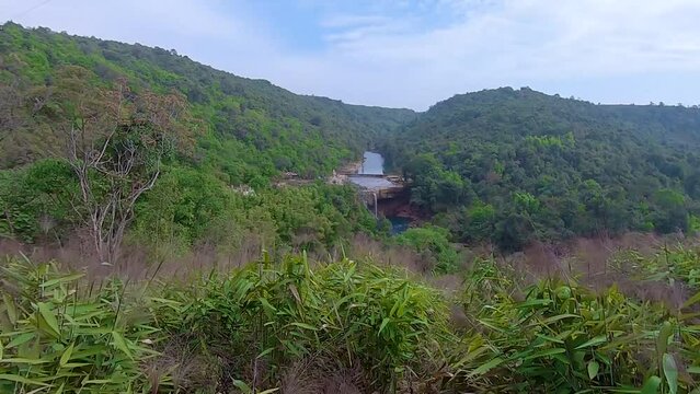 dense green forests with pristine waterfall at day from flat angle video is taken at Krang Suri Falls meghalaya north east india.