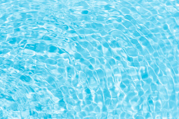  Blue water with ripples on the surface. Defocus blurred transparent blue colored clear calm water surface texture with splashes and bubbles. Water waves with shining pattern texture background.