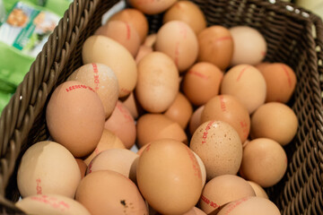 Basket full of marked brown eggs