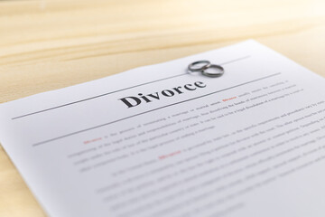Two wedding rings above  decree document. Divorce and separation concept. Family  break up or divorce, conflict concept. terminating a marriage or marital union. Divorce laws.