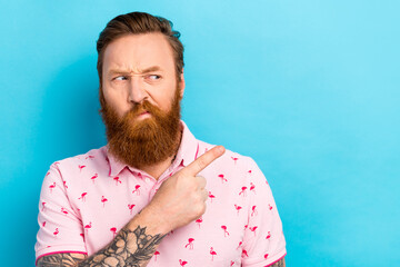 Portrait of dissatisfied gloomy man with cool tattoo wear flamingo t-shirt indicating look empty...