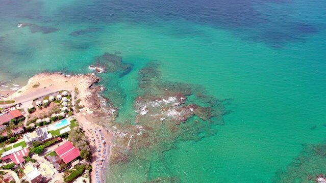 Aerial view of a beach in Hersonissos, on the Greek island of Crete. Slow-motion view of the waves in the sea.