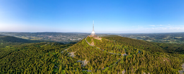 Sunny evening at Jested Mountain with unique building on the summit. Liberec, Czech Republic. Aerial view from drone.