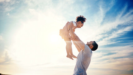 Father lifting kid, air and blue sky with family, travel and freedom outdoor, bonding and ocean...