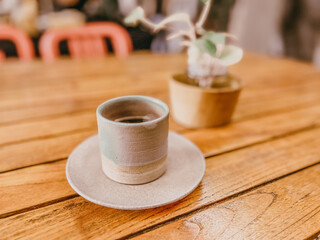 cup of coffee on wooden table