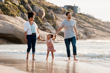 Family, beach and holding hands, parents and child with travel and bonding, love and walking together outdoor. Vacation, ocean and happy people in nature, man and woman with kid, sun and adventure