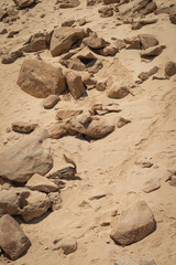 Fototapeta na wymiar Desert landscape with sand and rocks of a beach on Fuerteventura island. Fuerteventura, Canary Islands, Spain