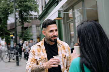 Latin man and his girlfriend drinking coffee