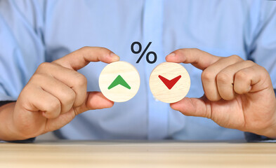 Financial interest rate holding wooden block with percentage sign and up arrow, financial growth, interest rate increase, inflation rate, selling price and tax hike concept and rate simulation	
