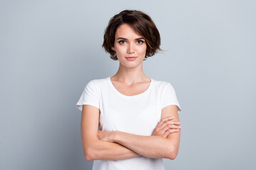 Photo of pretty confident woman dressed white t-shirt arms crossed isolated grey color background