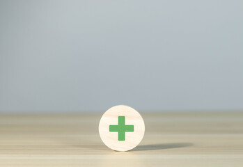 Wooden blocks showing plus and minus signs. The concept of antithesis. Decision making. Positive or...