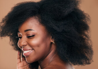 Beauty, face and hair with a model black woman in studio on a brown background for natural...