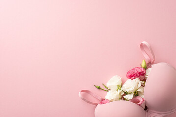 Breast cancer awareness representation: Top view shot of a bra filled with elegant eustoma flowers...