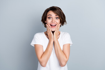 Photo of funky excited woman dressed white t-shirt arms cheeks open mouth isolated grey color background