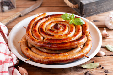 Baked homemade sausage close up on wooden table