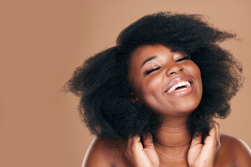 Smile, black woman and hair care for afro, natural and beauty on a brown studio background. Growth,...