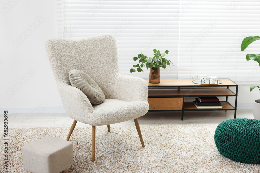 Poster Comfortable armchair, table and houseplant in living room. Interior design