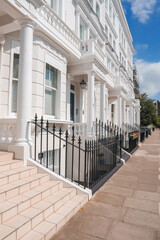 Steps of luxurious property in Pembridge Gardens. Residential house by footpath. Apartment in London on sunny day.