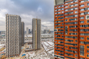 A new residential neighborhood in the capital Moscow with high-rise apartment buildings on a winter day with snow in the top view.