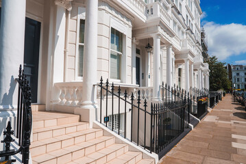 Steps of luxurious property in Pembridge Gardens. Modern residential house by footpath. Apartment in London on sunny day.
