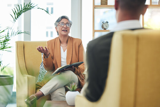 Talking, psychologist and man for therapy, advice or discussion of mental health. Meeting, consultation and a female therapist with a patient for counseling support, conversation or help in an office