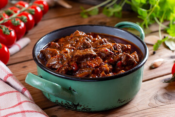 Tasty Hungarian goulash soup bograch close-up on a table and ingredients. Horizontal