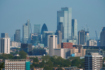 Obraz premium Scenic view of crowded cityscape with blue sky in background. Tall skyscraper amidst residential buildings. High angle view of modern development in London.