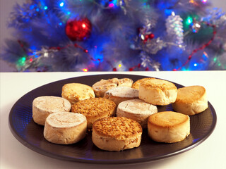 Delicacies polvorones and mantecados in dark plate