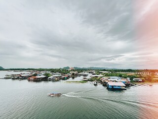 Fototapeta premium Thailand style boat on the river with floating old town