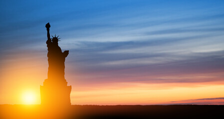 Statue of Liberty on background of sunset sky. Greeting card for Independence Day. USA celebration.