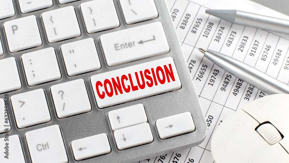 Aufkleber conclusion text on a keyboard wirh chart and pencil