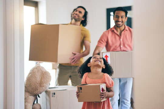 Happy, family and box moving with child and gay parents in new home with cardboard package. Smile, kid and lgbt people together with real estate and property mortgage in a house helping father