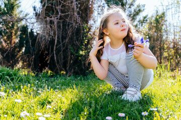 Cheerful girl with Down syndrome playing outdoors in the yard.Summer seasonal outdoor activities...