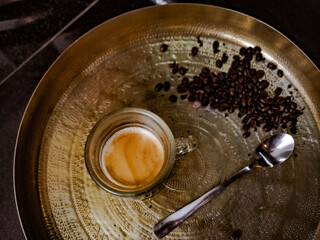 turkish strong coffee in a glass from a cafe. coffee beans